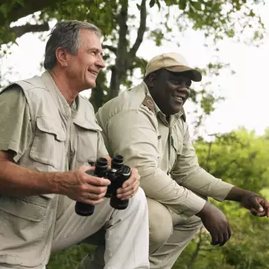 Senior man and Safari guide man smiling together